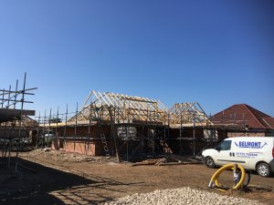 scaffolding surround bungalows under construction - roofing - image 3